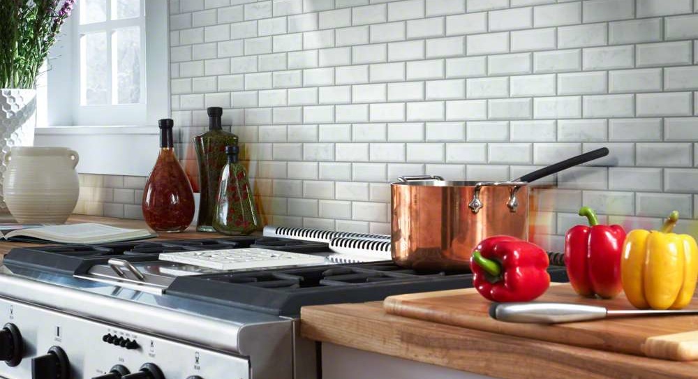 The backsplash is a classic white 3x6-inch subway tile with a soft matte finish and slightly rounded edges.