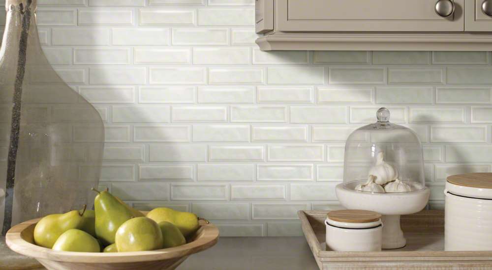 The backsplash features 3x6-inch white subway tiles with a handcrafted, beveled edge and soft, glossy finish.